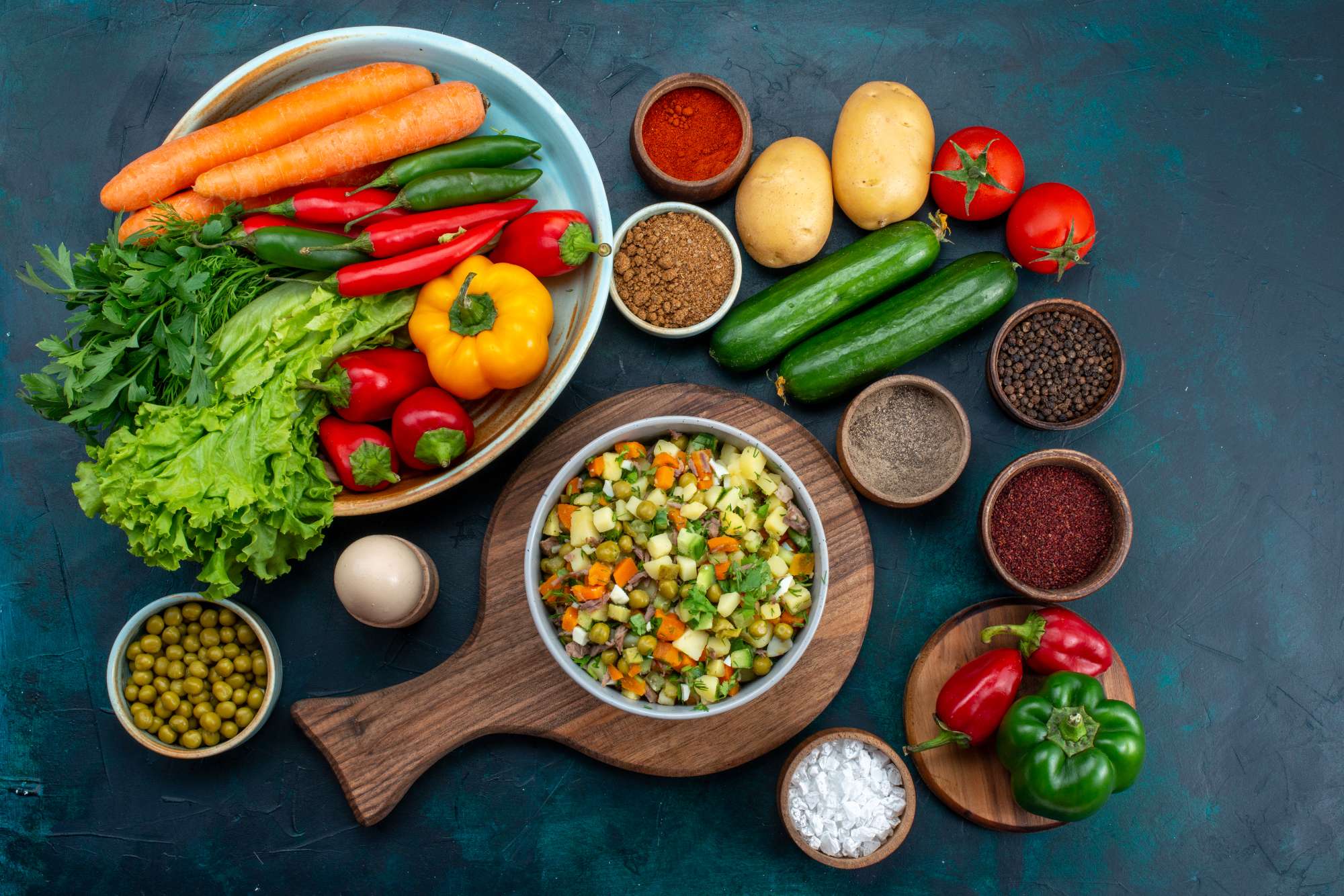 top-view-sliced-vegetable-salad-peppered-with-chicken-slices-inside-plate-with-fresh-vegetables-blue-desk-snack-lunch-salad-vegetable-food.jpg